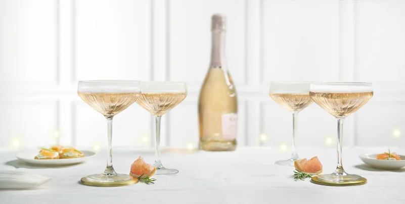 "Glory" champagne glasses on a setup table