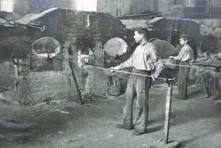 Black and white photography of two men moulding glass at CRISAL (Alcobaça) in 1944