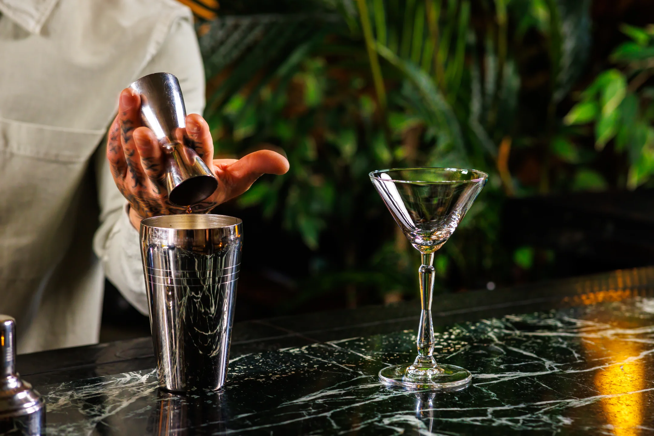 Bartender preparing a drink in a "New Era Martini" by ONIS