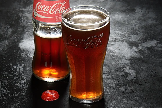 A customized tumbler for Coca-Cola filled with the drink